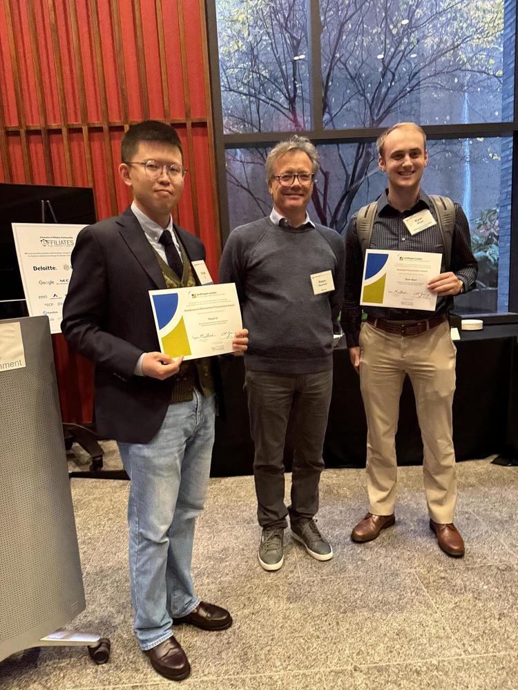 2 researchers and a sponsor with poster awards